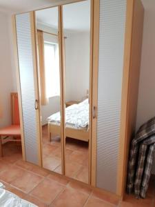 a mirror in a room with a bedroom at Haus Kiki in Dornumersiel +5 photos