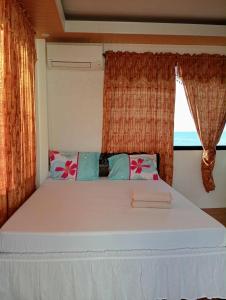 a large bed in a room with a window at Bulls residence seaview in Toledo City
