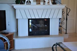 a living room with a fireplace with a television at Beachfront Villa Gradina in Vela Luka