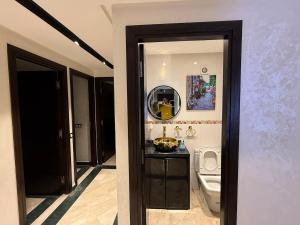 a bathroom with a toilet and a mirror at Saaid Mouadin in Casablanca +10 photos