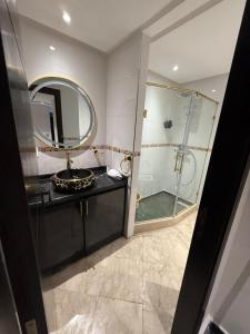 a bathroom with a sink and a shower with a mirror at Saaid Mouadin in Casablanca