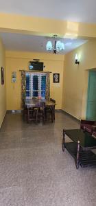a living room with a table and a couch at The Green Regency Annexe in Munnar