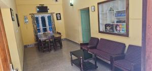 an empty waiting room with two chairs and a table at The Green Regency Annexe in Munnar