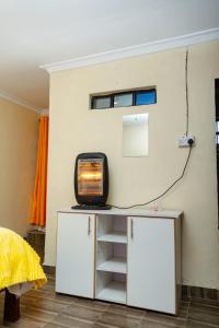 a tv sitting on a table in a room at Micasa Pent House MAIN in Limuru +3 photos