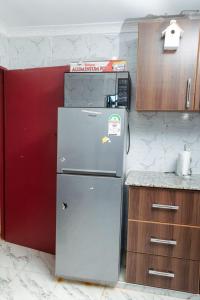 a kitchen with a white refrigerator in a room at Micasa Pent House MAIN in Limuru