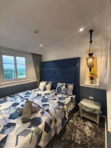 a bedroom with a blue and white bed and a window at Seven seas cote Apartment in Na Jomtien +34 photos