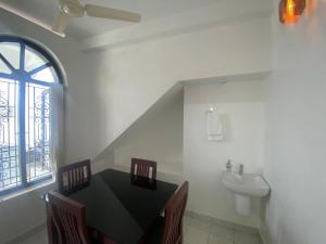 a dining room with a table and a sink at DOWN TOWN HOLIDAYS Kovalam in Kovalam +47 photos