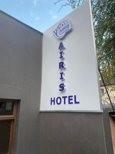 a sign for a hotel on the side of a building at AIRIS Residence in Almaty