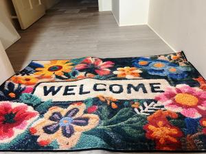 a welcome rug on a floor with a welcome sign on it at No37 隱居 in Dajia +2 photos