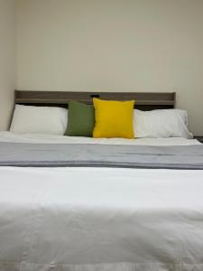a large bed with four pillows on it at No37 隱居 in Dajia