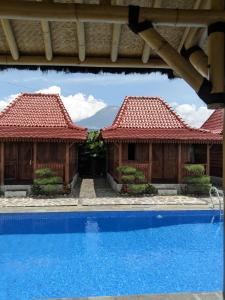 a view of two houses with a swimming pool at Katah Montana Villa in Tonoboyo +6 photos