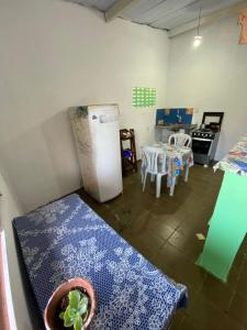 uma cozinha com uma mesa e um frigorífico num quarto em Apto Centro Pipa em Pipa