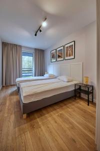 a large bedroom with two beds and a window at Przytulne M w Pcimiu in Pcim
