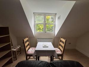 a dining room with a table and chairs and a window at Nether Edge Apartments in Sheffield