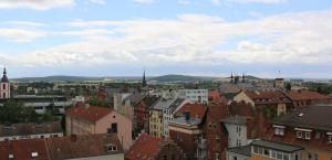 a view of a city with roofs and buildings at SleepySleepy Hotel Fulda in Fulda