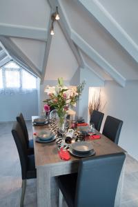 a dining room table with black chairs and a table centerpiece at 7th Heaven in Lygia