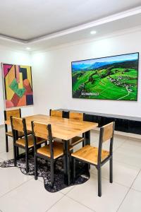 a dining room with a wooden table and chairs at Tsholofelo East Guesthouse in Gaborone