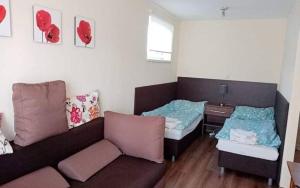 a living room with two beds and a couch at Chatka Tatry in Veľký Slavkov