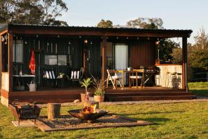 a house with a fire pit in front of it at The Bunker Malniri Park in Wilberforce