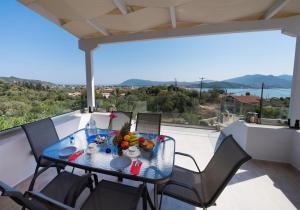 a table with a bowl of fruit on a balcony at 7th Heaven in Lygia