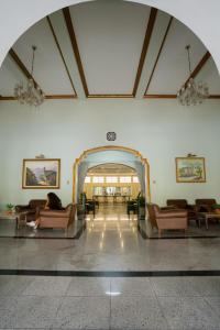 a lobby with couches and chairs in a building at Hotel Minas Gerais in Poços de Caldas +147 photos