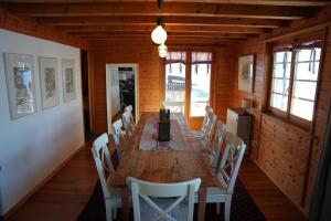 a dining room with a long wooden table and chairs at Chalet Rossier Mayens de Sion aux 4 Vallées in Agettes