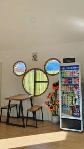 a refrigerator filled with drinks next to a table at ทุ่งเศรษฐีโฮมสเตย์แอนด์คาเฟ่ in Chiang Dao +28 photos
