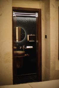a mirror in a bathroom with a sink at Hotel Estara in Urfa