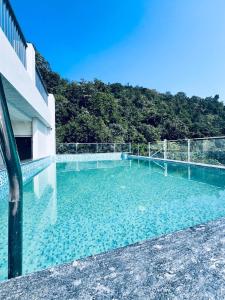 a swimming pool on the side of a building at Roots & Peaks in Rishīkesh