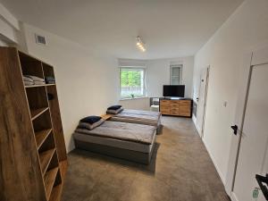 a living room with a couch and a tv in it at Milten Pniów in Pniów +14 photos