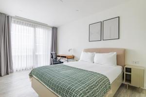a hotel room with a bed and a window at Blueground Stratford rooftop nr Olympic Park LON-690 in London +27 photos