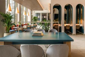 a blue table in a room with chairs and tables at Blueground Stratford rooftop nr Olympic Park LON-690 in London