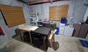 a kitchen with a table and chairs in a room at J Travel Trail Homestay in Hubangon, Camiguin in Camiguin
