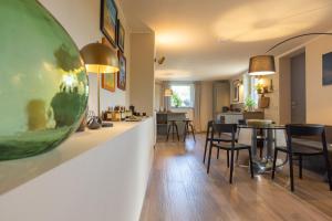 a living room with a large green bowl on a wall at Guest House Ferri e Zani in Cavatore
