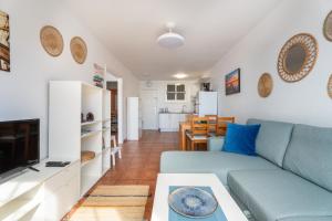 a living room with a couch and a tv at Two bedroom apartment with sea view in Los Abrigos in Los Abrigos