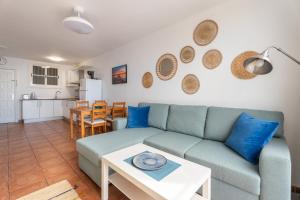 a living room with a couch and a table at Two bedroom apartment with sea view in Los Abrigos in Los Abrigos +35 photos