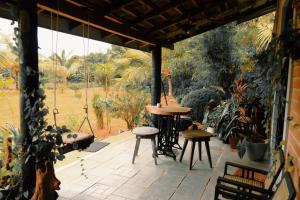 a patio with a table and two stools on it at Birds of Paradise Surf and Yoga Boutique & Retreat in Weligama