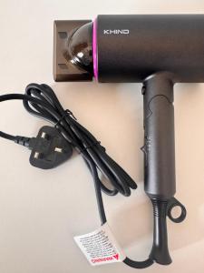 a camera with a charger on a wall at Comfy Hut-KLIA SEPANG in Sepang