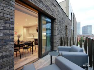 a living room with a blue couch and a table at Pappilo at The Heim Residences in Manchester