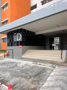 a building with a d sign on the side of it at Comfy Hut-KLIA SEPANG in Sepang