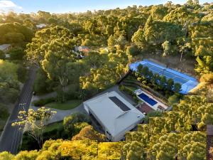 an aerial view of a house in the forest at Luxury Resort Studio Apartment Retreat with Pool, Tennis & Alfresco 