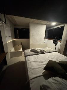 a bedroom with a bed and a bath tub at Mirante de itaipava in Itaipava