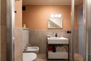 a bathroom with a sink and a toilet at Guest House Ferri e Zani in Cavatore +25 photos