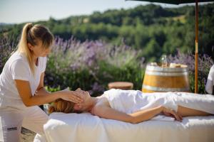 a woman giving a woman a massage on a bed at Guest House Ferri e Zani in Cavatore