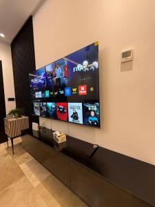 a flat screen tv hanging on a wall at Appartement a Malabata hills in Tangier