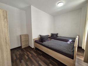 a bedroom with two beds and a dresser in it at Mikra Homes24 in Meerane in Meerane