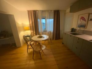 a kitchen with a table and chairs and a sink at Apartment Laura in Jenig