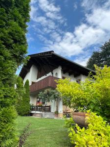a house with a gambrel roof on top of a yard at Apartment Laura in Jenig +18 photos