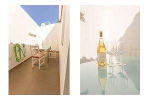 a bottle of wine sitting on a table with two wine glasses at Modern 2BR House Near Tavira Castle in Tavira