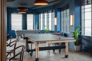 eine Tischtennisplatte in einem Zimmer mit blauen Wänden in der Unterkunft StayCozy in Croydon in Croydon